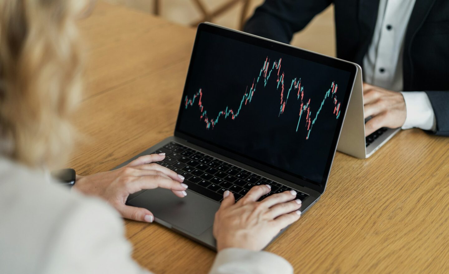 Trading stocks online on the trading exchange colleagues team a woman and a man in business suits in