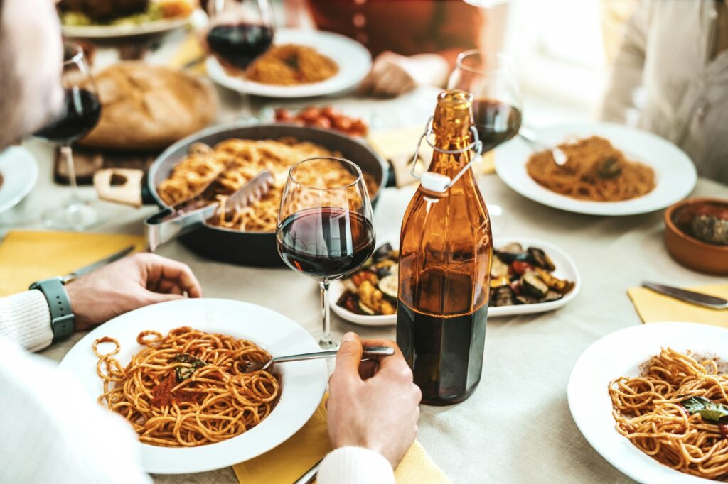Group of friends having a pasta dinner party at restaurant