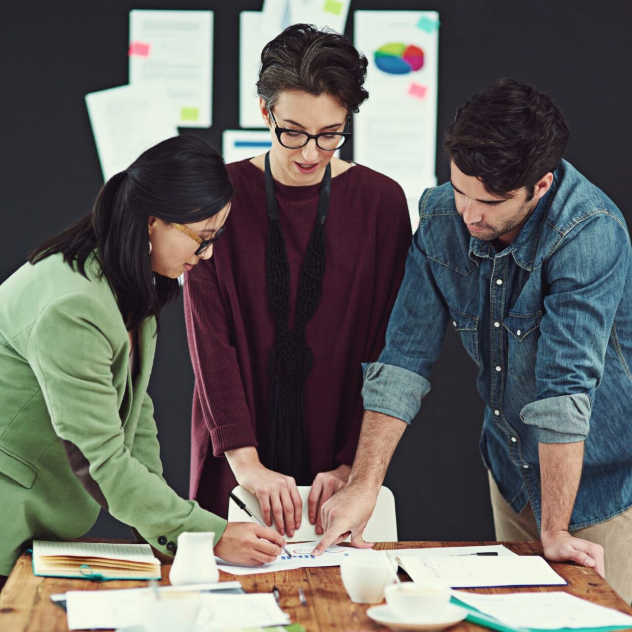 Cropped shot of a group of young creatives having a meeting in a modern office