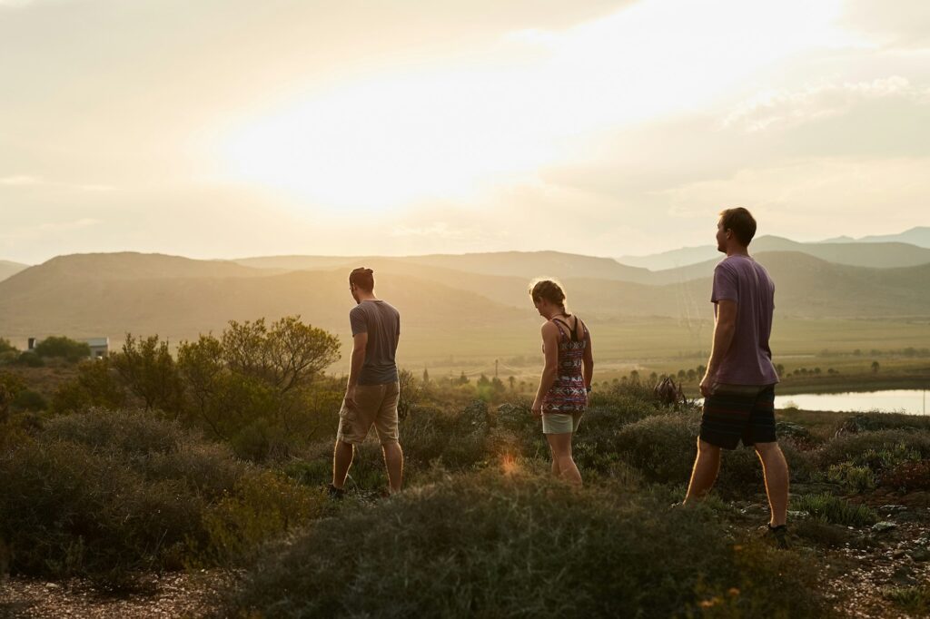 Life is better in hiking boots. Rearview shot of three young hikers on a mountain trail.