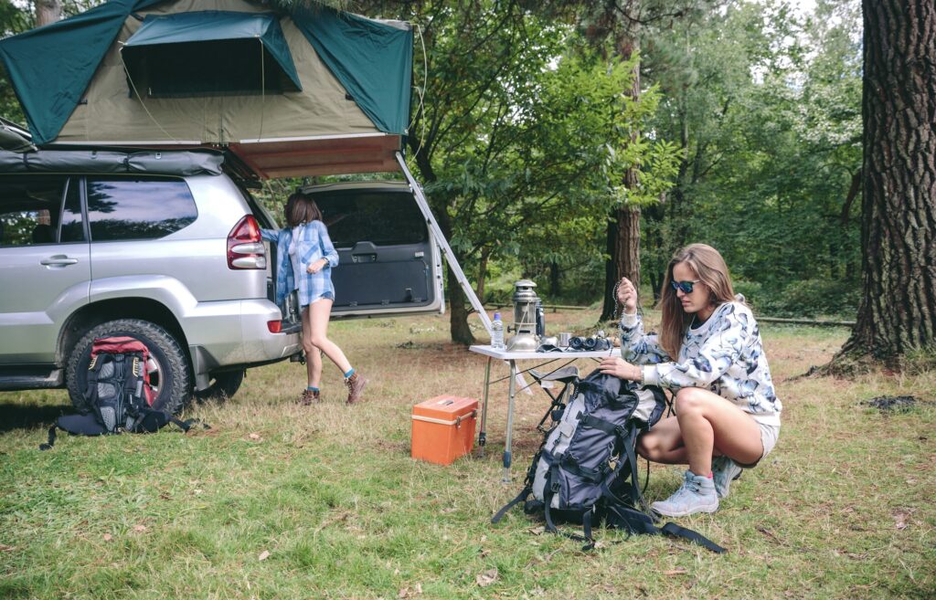 Woman preparing backpack for a hiking trip