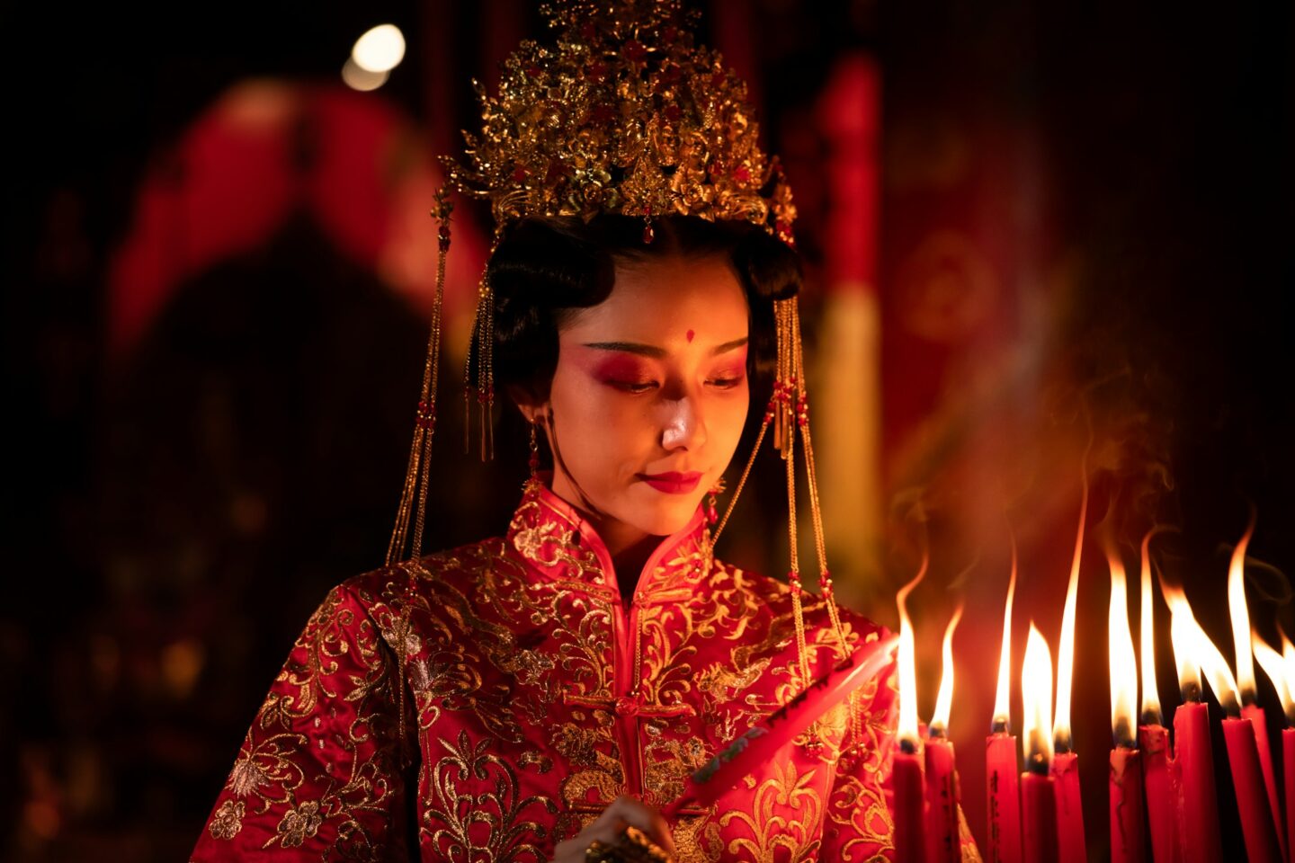 Chinese woman make wishes, pray, and light candles.